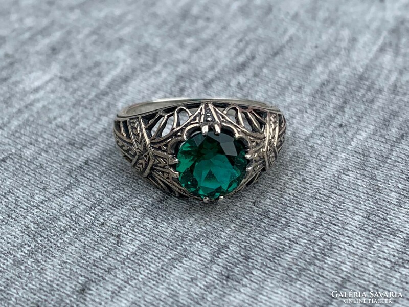 Women's silver ring with openwork pattern with green stones