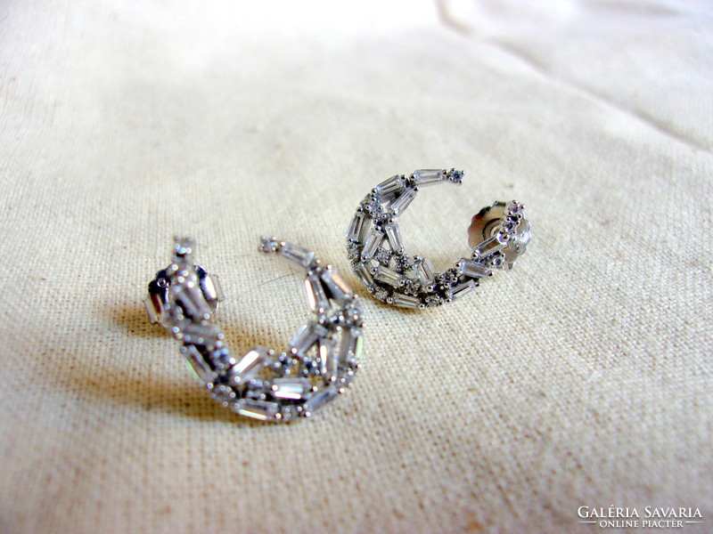 Silver earrings richly studded with stones