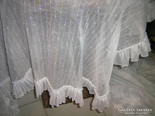 A beautiful pair of special densely ruffled curtains with rounded corners