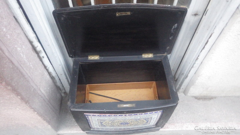 Older, openable wooden chest with painted faience inlay on the front, storage