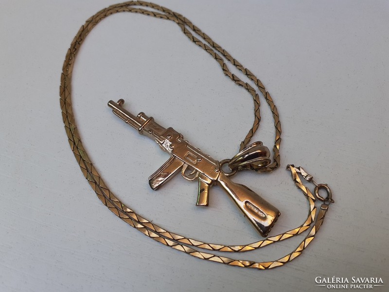 Old, beautiful, richly gilded military pendant on a richly gilded chain