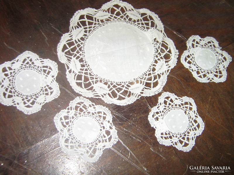 Cute little machine-embroidered lace tablecloths, coasters, or showcase tablecloths