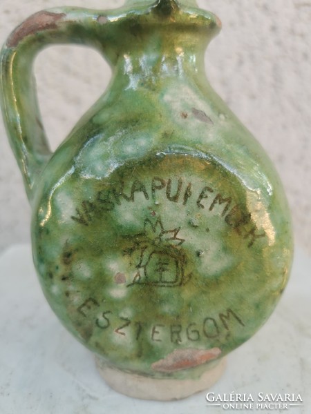 A small jar with an inscription, flattened sides