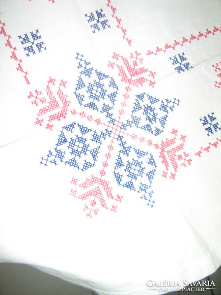 Beautiful folk traditional embroidered cross-stitched tablecloth with a blue and red pattern