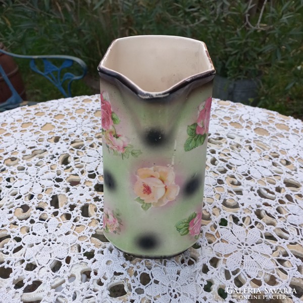 Antique earthenware jug with flowers