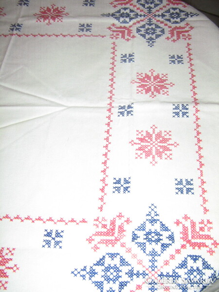 Beautiful folk traditional embroidered cross-stitched tablecloth with a blue and red pattern