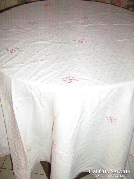 Spotted oval damask tablecloth with lacy edges embroidered with pink roses in beautiful fabric