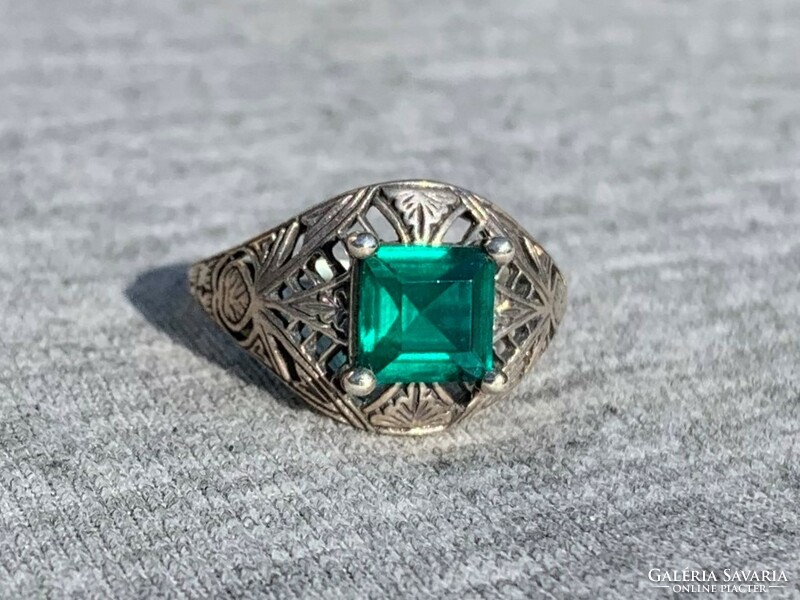 Women's silver ring with openwork pattern with green stones