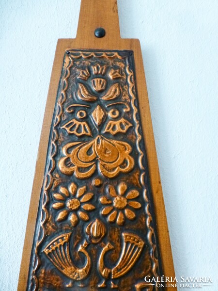 Wooden wall decoration in the shape of a manger with copper overlay