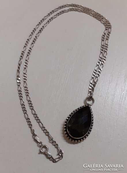 In good condition, a necklace with a carved pattern marked on it with a marked silver pattern with a silver set stone pendant