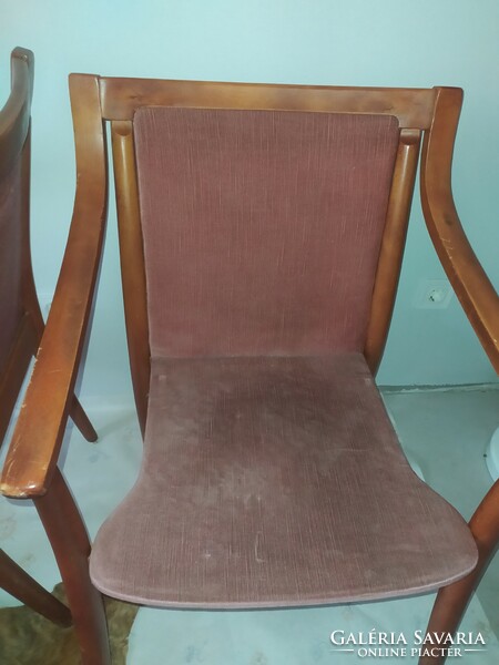 A pair of vintage chairs with curved lines