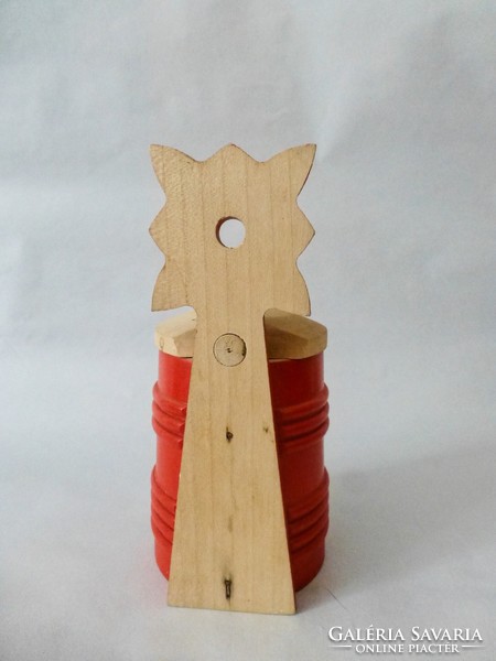 Carved wooden salt shaker with a red Hungarian pattern