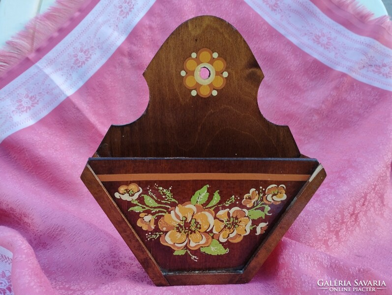 Wall-mounted wooden napkin holder with folk flower decoration