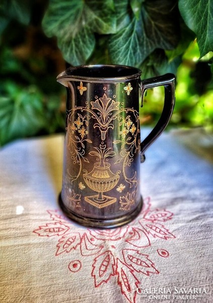 A special antique English jug made of glazed black ceramic with Victorian patterns, a rarity!