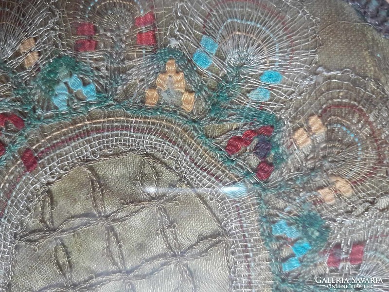 Very unique wall decoration tapestry, embroidered with gold thread, placed behind glass.