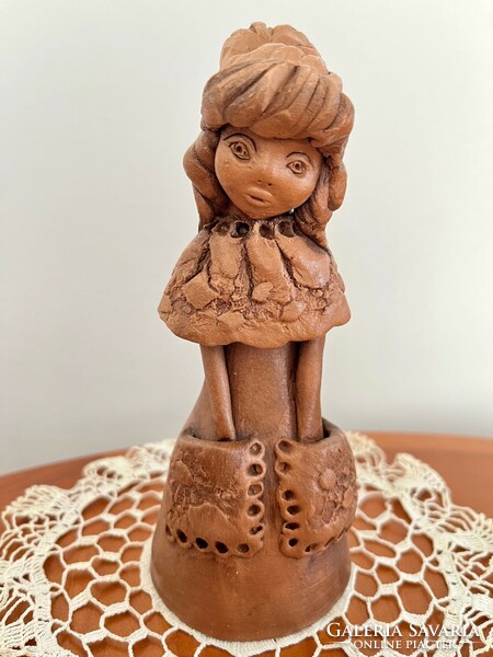 Ceramic figurine of a girl in a dress with pockets