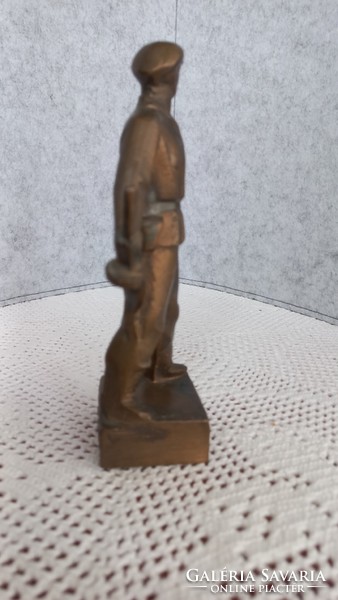 Retro bronze statue of a worker's guard, with the inscription 