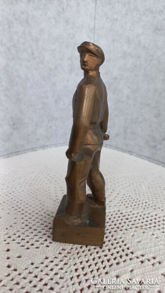 Retro bronze statue of a worker's guard, with the inscription 