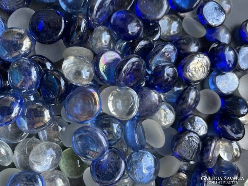 Lots of translucent, iridescent ornamental stones and pebbles with blue-white tones