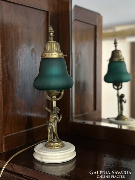 Elegant table lamp with a green shade and a bronze statue on a marble base
