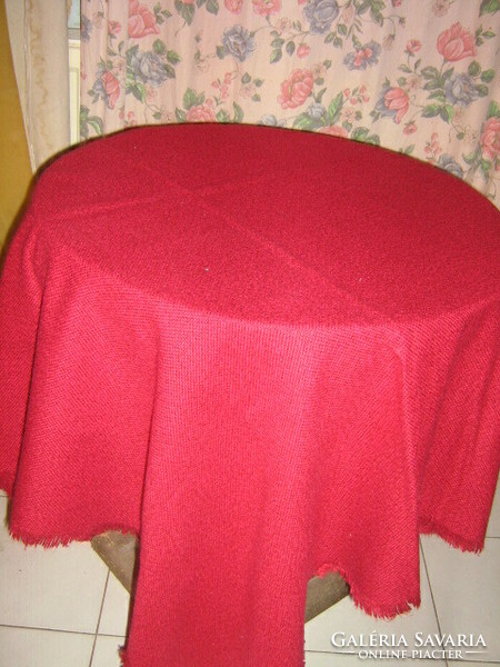 Beautiful burgundy-dark pink woven tablecloth with fringed edges