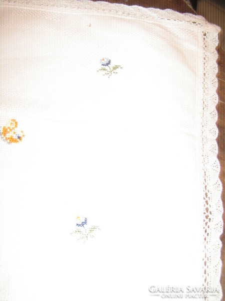 Beautiful hand embroidered snow-white woven tablecloth with lacy edges