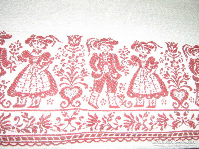 Beautiful vintage bavarian motif burst on white background Tyrolean girl-boy and floral kind woven tablecloth