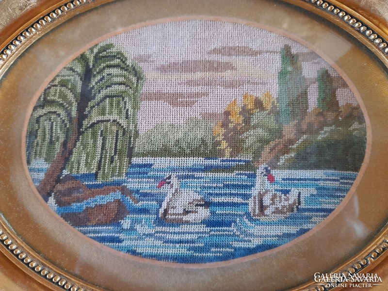 Antique tapestry picture with a couple of swans