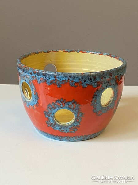 Red and blue retro ceramic pot with holes