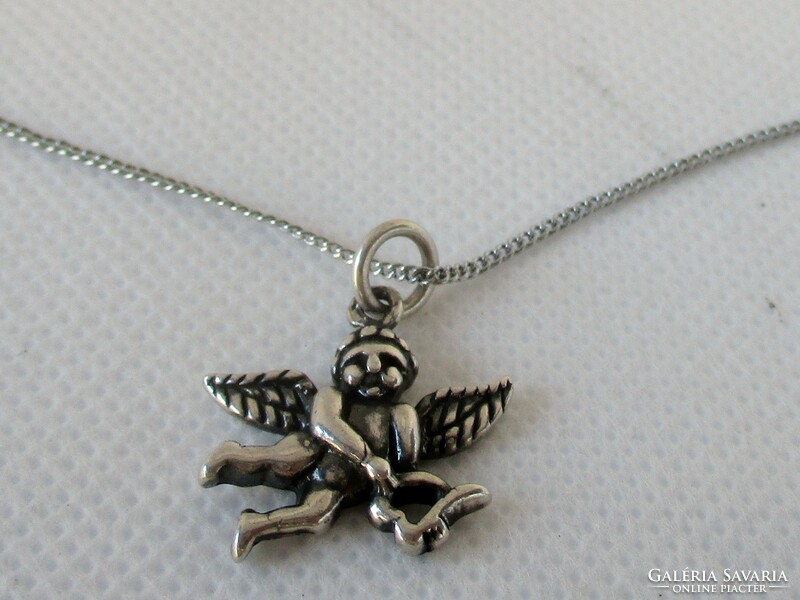 Old silver necklace with a beautiful little angel