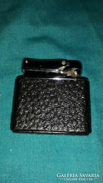 Antique unmarked black leather - metal cased lighter as shown in pictures