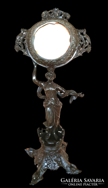 Female sculpture on antique table mirror