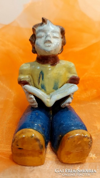 Glazed ceramic figure, reading boy