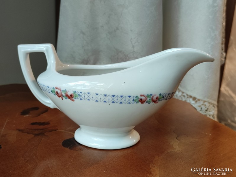 A beautiful antique porcelain sauce pourer with a beautiful geometric border and studded with small flowers