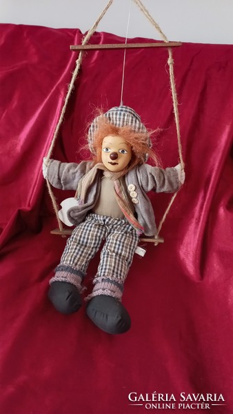 Clown sitting on a swing with a porcelain head, kunsthanwerk topline austria marked, 40 cm, hanging: 60 x 27 cm