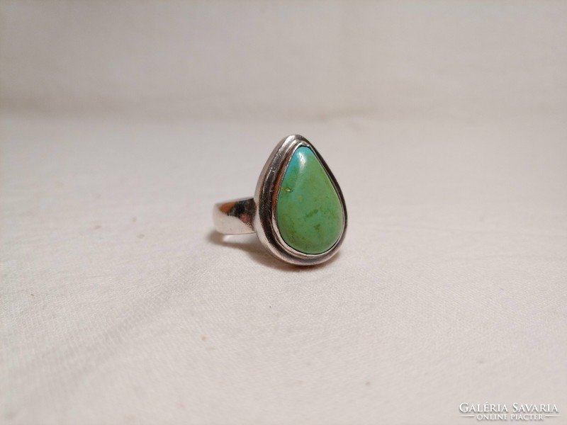 Old silver ring with a large greenish turquoise