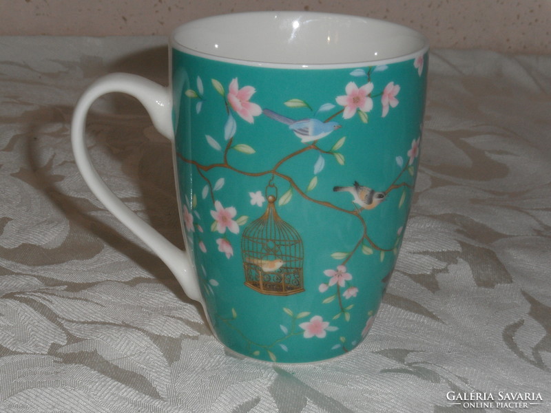 Porcelain mug with bird cage and flowers