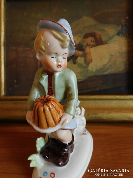 Old German porcelain figure - a little boy protecting his dog from his dog