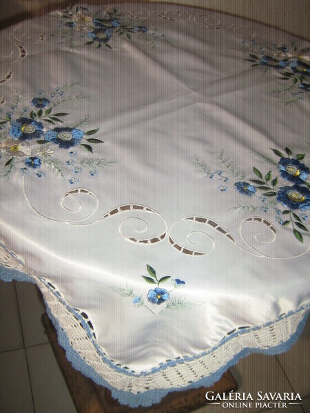 Beautiful machine-embroidered tablecloth with hand-crocheted edges