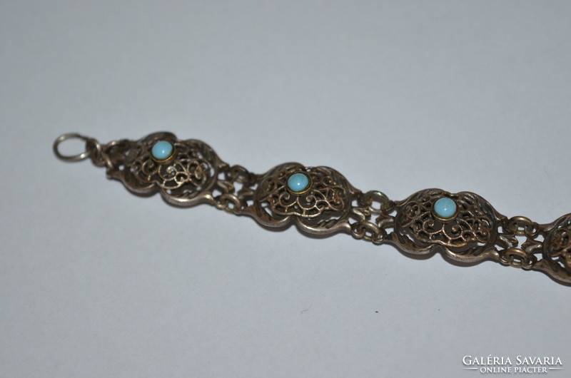 Antique effect metal bracelet with blue stones