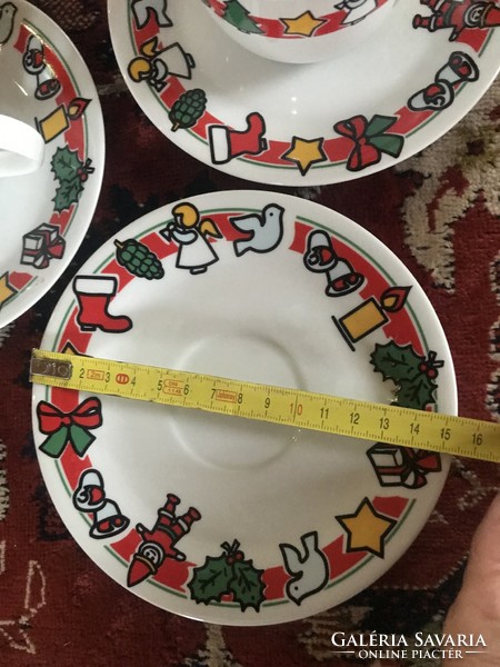 Coffee cups with their plates with Christmas decor