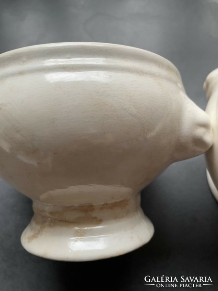 A mature earthenware soup cup with a lion's head