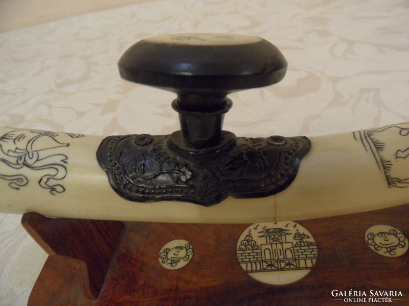 Far Eastern hand-painted, bone opium pipe on a wooden stand