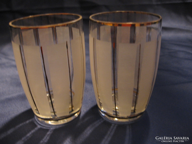 A pair of antique glasses with gold and ground stripes