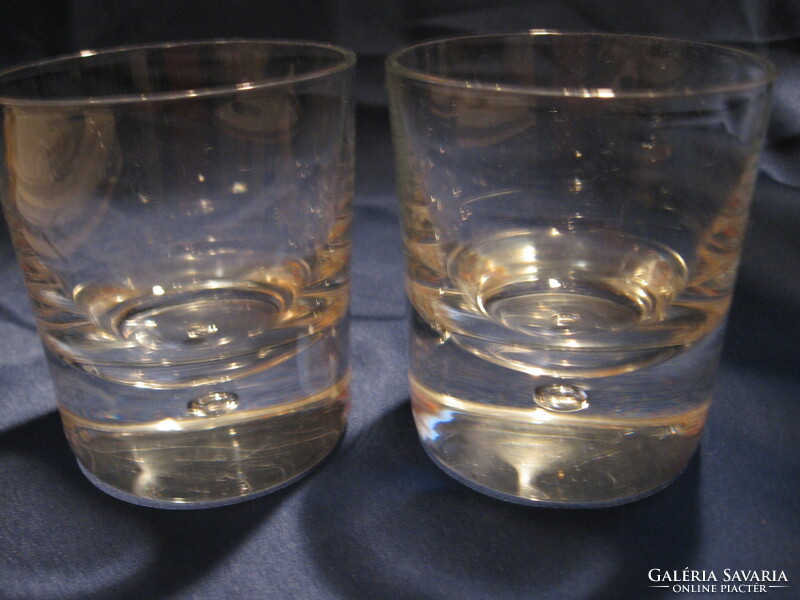 A pair of crystal glasses with bubbles in the soles