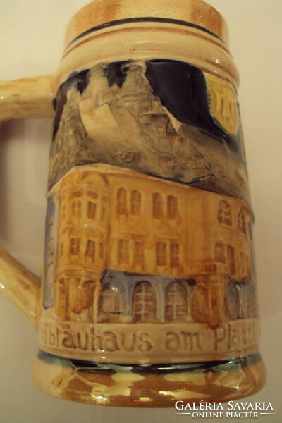 German ceramic beer mug with a plastic surface, with the inscription Munich on the rim.