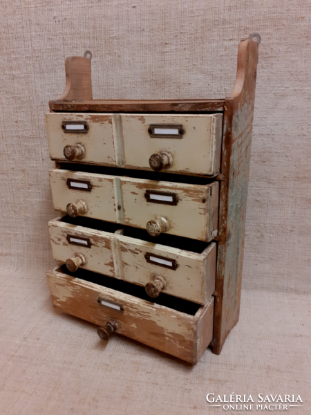 Old small wall-mounted multi-drawer spice cabinet