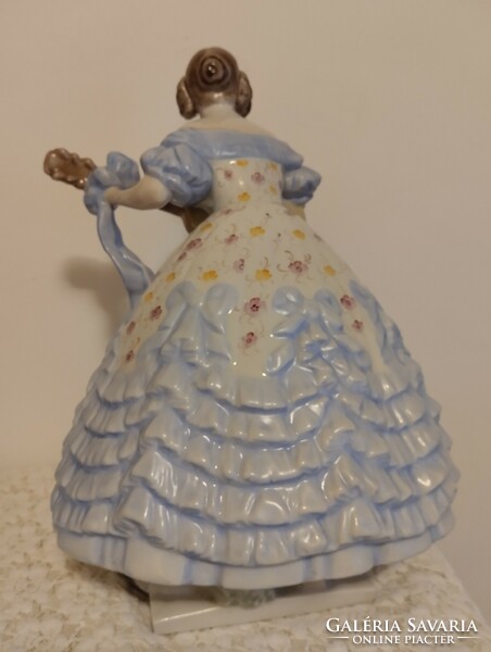 A large porcelain statue of Mrs. Déryn in a blue dress from Herend