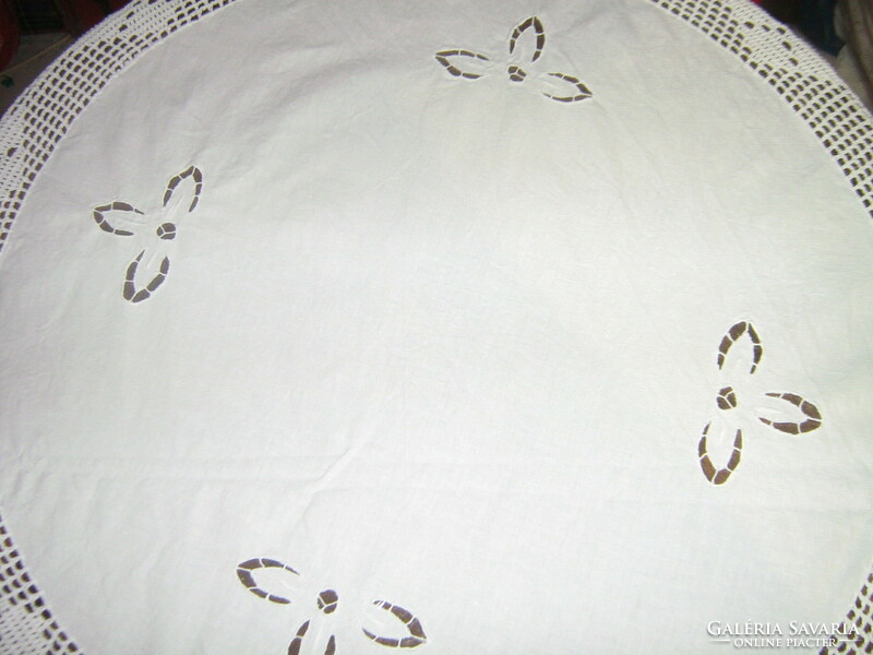 Beautiful round white tablecloth with hand-crocheted edges and inserts