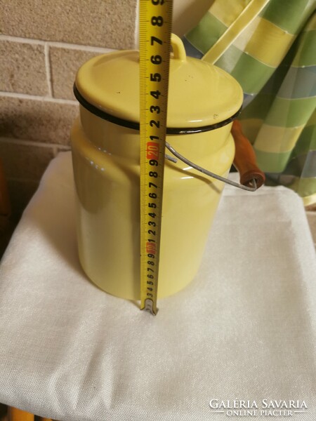 Old 3 l yellow enameled milk jug with wooden handle.